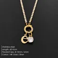 Titanium steel initial 'e' charm necklace with sparkling CZ pendant in polished 14K gold - Letter E (XNL0103)
