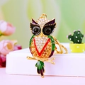 Golden owl keychain with colorful enamel and crystal accents on a white stand - A430 Owl E Green