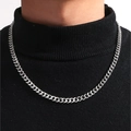 Polished silver Cuban link chain necklace worn by a model on a black turtleneck sweater - Silver