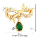 Pendentif nœud doré élégant avec cristaux blancs et goutte de pierre verte - Nœud Goutte Verte