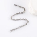 Polished silver stainless steel O-chain bracelet with lobster clasp on white background - Bracelet