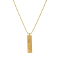Macro detail of 18K gold plated Virgo zodiac tarot pendant with relief and crystal - Virgo