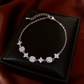 Close-up of 18K gold plated clover bracelet with sparkling zircons and adjustable clasp - Real Gold Plated / Silver