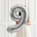 Silver number 9 foil balloon for birthday party decor held by a girl in white dress - Silver Style 9