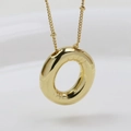 Macro shot of puffy golden balloon style pendant with polished finish on a bead chain - Letter O (Necklace)