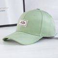 Detailed side view of light green cotton baseball cap with AD vintage patch - Green + Brown Label