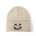 Beige knitted beanie with black embroidered X-eye smiley face street style detail - One Size / Beige