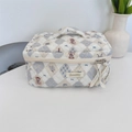 Quilted makeup bag detail with bear patterns, plaid design, and ribbon zipper pull - Diamond Bear