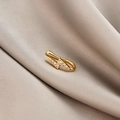 Detailed macro view of a gold-toned lightning bolt ear cuff with micro-pave zircons - Lightning (E5689-22)