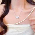 Titanium steel bow necklace with iridescent shell butterfly pendant on a female model - Iridescent Butterfly Pendant (X1416) / Silver/Blue Pink Gradient