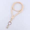 Detail of wooden beads lanyard with engraved bear pattern, tassel, and gold keyring - Bear