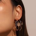 Gothic style oversized gold spider hoop earrings worn by a model for a bold vintage look - Large Hoop Spider Style / KC Gold (KC Gold H-225)