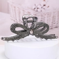 Elegant dark grey rhinestone bow hair claw clip with grey pearl on white display stand - Gun Black - Bow Rhinestone