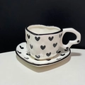 Handcrafted ceramic coffee cup and saucer set with black heart pattern on white glaze - Black Heart Cup & Saucer