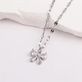 Macro shot of silver butterfly pendant with zircon stones on textured stone surface - Style 1-White Gold Bowknot