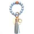 Detail of grey silicone beads, hexagonal wood bead, and leather tassel on keychain - Gray