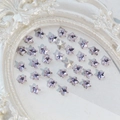Light purple star-shaped K9 crystal nail gems scattered on a white background - Star 8mm