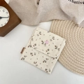 Detailed close-up of floral canvas pouch with pink snap button and brand label - Large / Beige