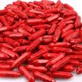 Close-up of red turquoise double-pointed hexagonal crystal columns for DIY jewelry - Red Howlite