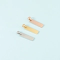 Macro view of polished rectangle pendants in silver, gold, and rose gold finishes - 6x22mm (MP012) / Steel