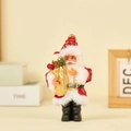 Plush Santa Claus figurine holding a golden gift bag with festive pine cones and berries - Gift Bag (Red Patch)