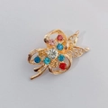 Golden flower brooch with colorful rhinestones in blue, red, and pink crystal settings - Colorful Hollow Flower