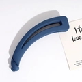 Top view of a large matte dark blue banana clip hair accessory with a twisted design - Navy Blue