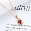 Close-up of a gold-plated oval pendant with a red gemstone and white zircon halo - Gold/Red Stone (Oval)