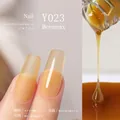 Amber gel nail polish Y023 showing matte and glossy finish on long almond nails - Y-023 Beeswax