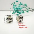 Detail of vintage silver spacer beads with floral engravings and 6mm large holes - Style 7 (Cross Floral Relief)