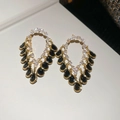 Macro detail of 18K gold plated drop earrings with white zircons and black gemstones - Gold Black Water Drop Fringe / Gold Black