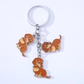 Macro view of detailed enamel dachshund dog charms on a silver metal keychain ring - Brown Series