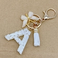 Letter A keychain with gold butterfly charm and white tassel for bag decoration - Letter A