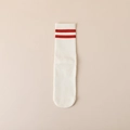 White yoga crew sock with red stripes and non-slip silicone grip on light beige background - Red Stripes / White