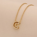 Macro shot of gold-plated necklace with a crystal-encrusted letter C pendant detail - Letter C