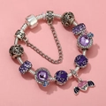 Macro detail of silver snake chain with purple faceted beads and pink heart wing charm - Sl023318/1216-5