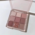 Nine-color eyeshadow palette with matte and shimmer pink tones in a clear acrylic case - Transparent Pink Tone Nude Palette