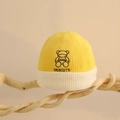 Detail showing the embroidered bear and DIDICUTE logo on winter knitted baby beanie - One Size (6 Months-2 Years) / Yellow