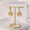 Close-up of 18k gold plated spiral pendant hoop earrings on a professional display - Spiral Circle Pendant