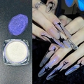 Macro shot of purple chameleon nail powder with iridescent aurora effect on long nails - Aurora Violet