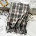 Soft grey plaid imitation cashmere scarf with fringe, folded in a cozy aesthetic setting - Gray
