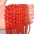 Close-up of vibrant red cat eye stone beads for DIY jewelry making held by a hand - 10mm/35pcs / Red