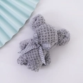 Dark gray coral fleece towel folded into a bear shape with a checkered ribbon bow - Grey Plaid (30*30)