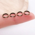 Antique bronze jump rings for DIY jewelry making shown on a fingertip for scale - Double Layer-0.7x5mm / Antique Bronze