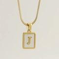 Macro shot of gold square shell pendant with letter J and sleek snake chain necklace - Letter J