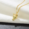 Golden fox head necklace with green zircon eyes on textured white fabric and stone background - Gold Fox Head-Green Eyes