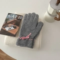 Grey knit gloves featuring a pink bow accent placed on a soft white winter scarf - Gloves / Gray