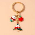 Detail view of Christmas keychain with red glove, apple, and tree charms with rhinestones - Christmas Glove Apple Tree