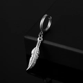 Macro shot of silver stainless steel feather earring with intricate textured details - Feather