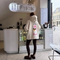 Oversized cream hoodie with humorous text and duck graphic on the back in a cozy cafe - S / Apricot